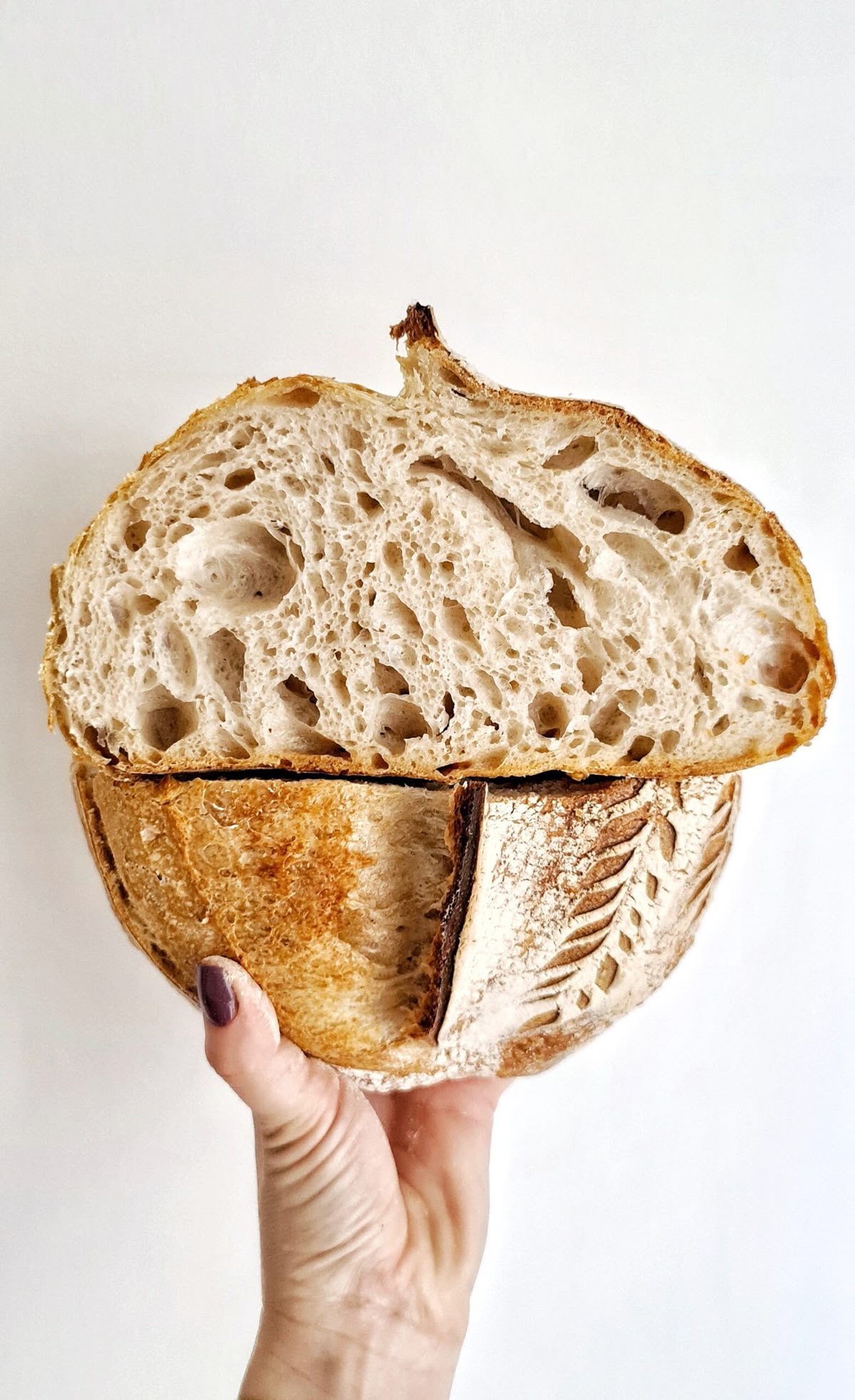 A sliced sourdough loaf showing crust, scoring and crumb
